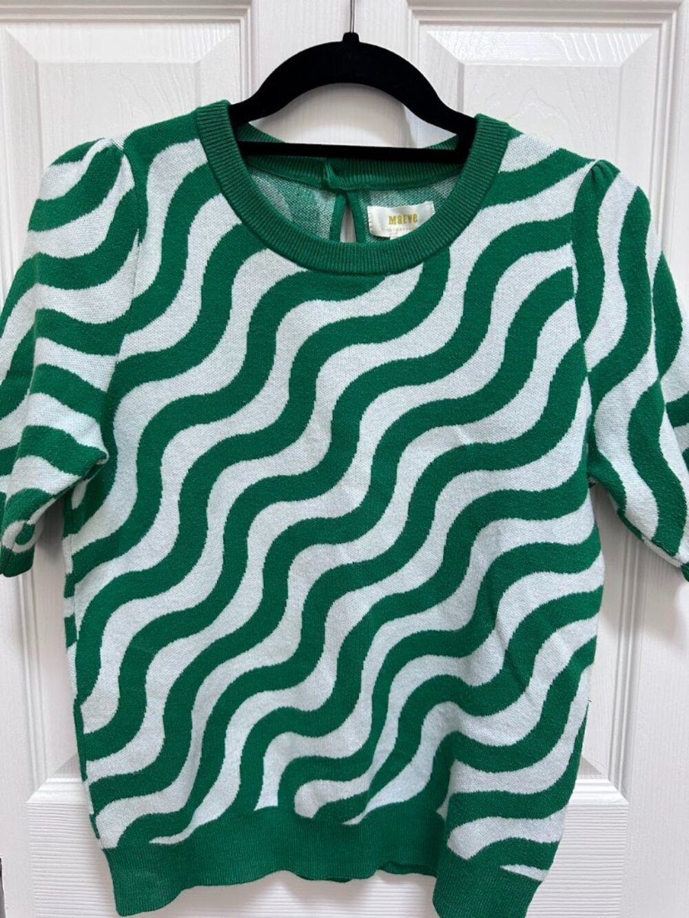 green and white wavy patterned sweater